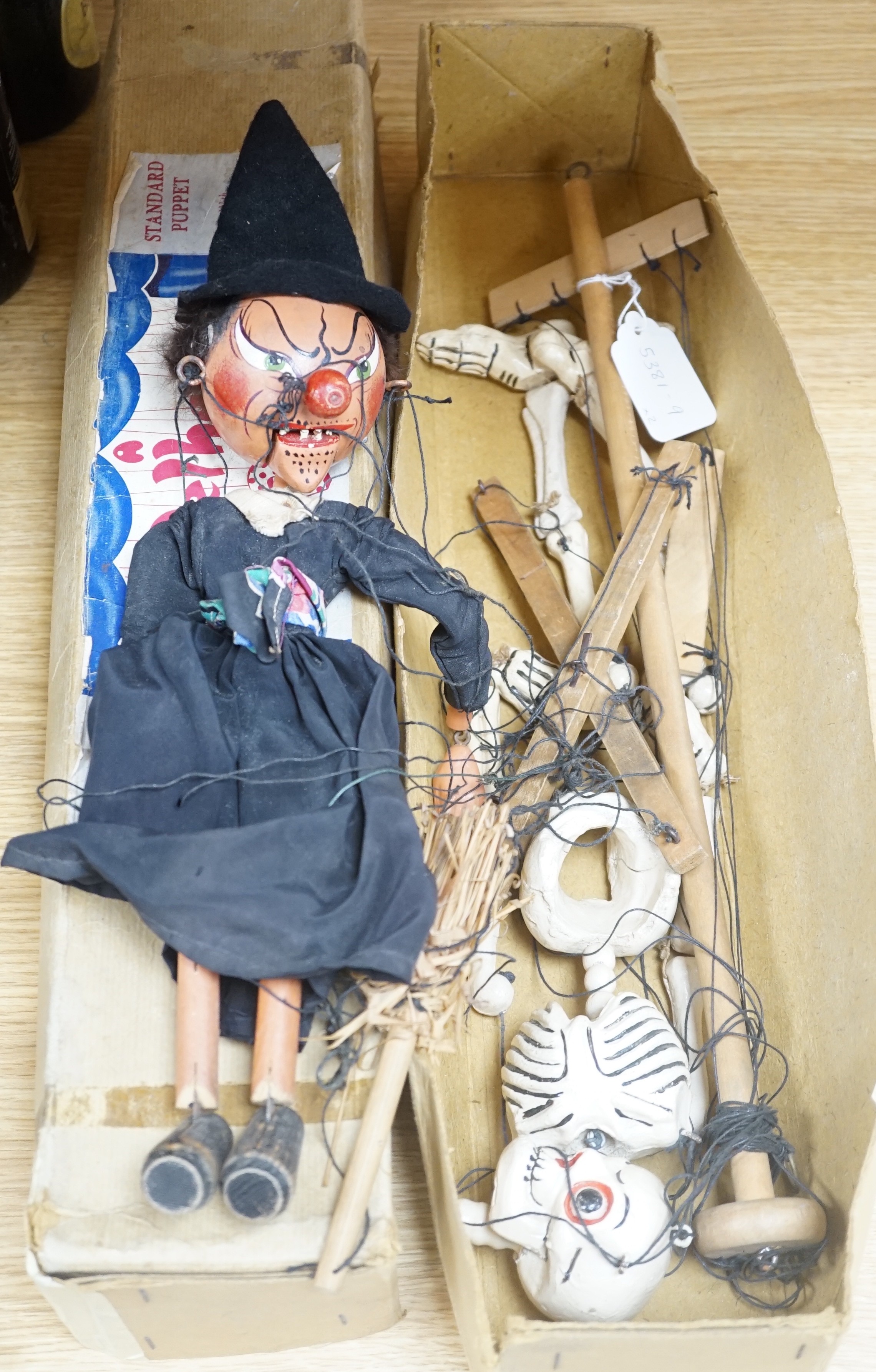 Two Pelham puppets, Skeleton and Witch and a box, Witch 38 cms high.